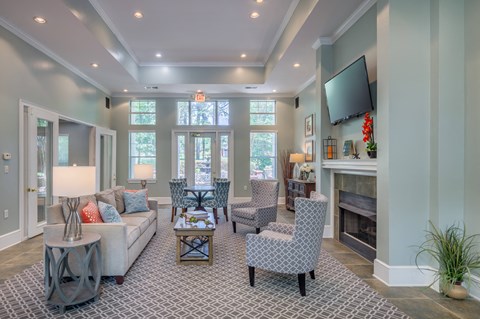 a living room with a couch and chairs and a fireplace
